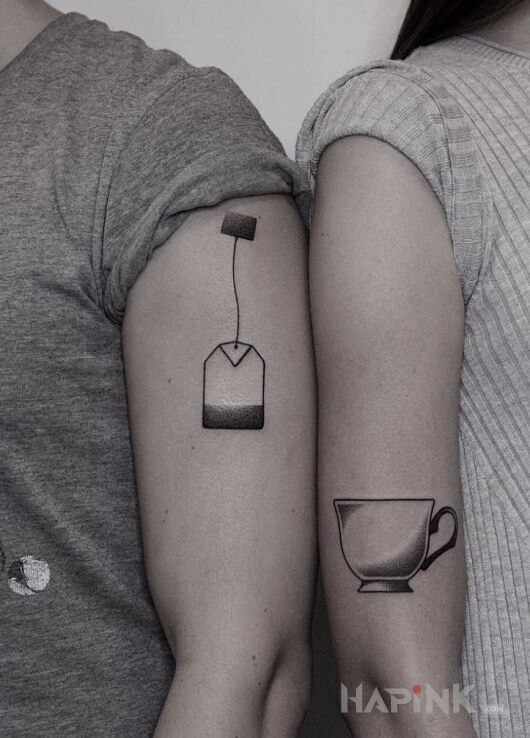 Tattoo Herbatka in black and gray motif and minimalistic style on the upper arm