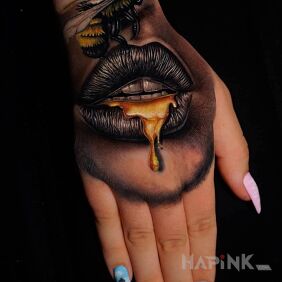 Tattoo Golden lips on the hand motif: 3D style: realistic