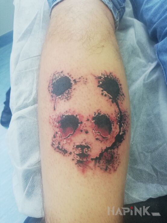 Tattoo Panda ? in black and gray motif and graphic / illustrative style on the calf