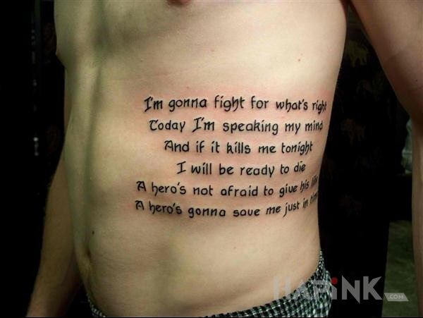 Tattoo Fragment tekstu in lettering motif on the ribs