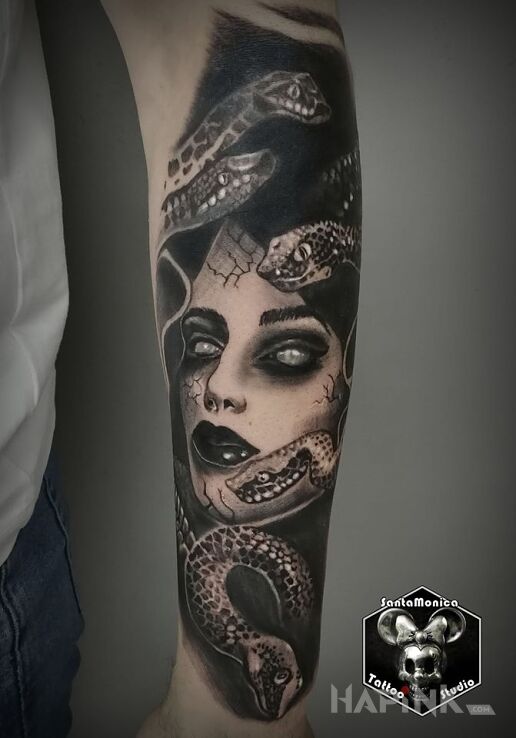 Tattoo Żmijki in black and gray motif and realistic style on the forearm