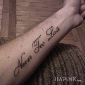 Tattoo Never Too Late on the forearm motif: lettering