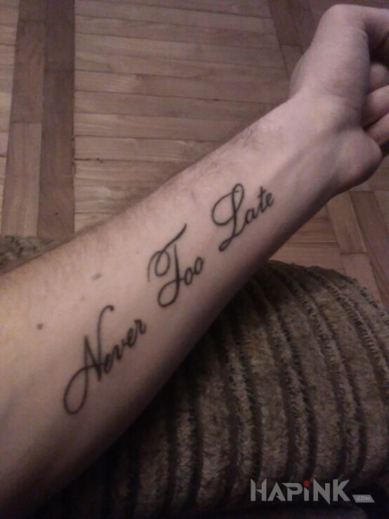 Tattoo Never Too Late in lettering motif on the forearm