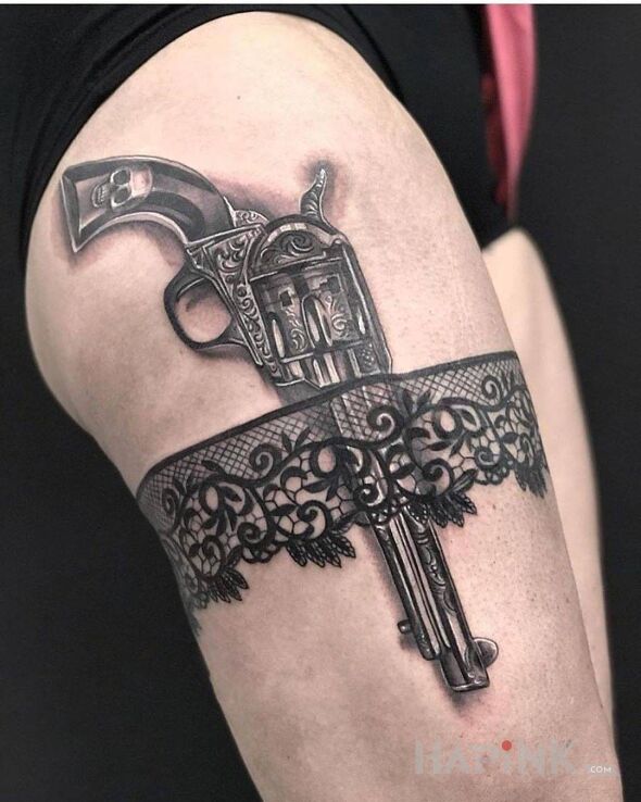 Tattoo Rewolwer in objects motif and realistic style on the leg