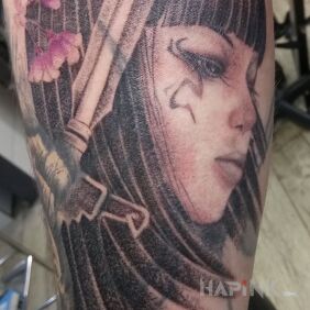 Tattoo A woman with flowers in her hair. on the forearm motif: black and gray style: realistic