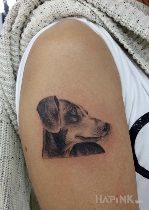 Tattoo Piesek. in animals motif and graphic / illustrative style on the upper arm