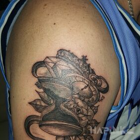 Tattoo Hourglass on the upper arm motif: black and gray style: graphic / illustrative