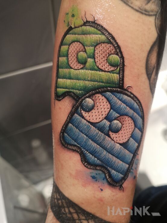 Tattoo Duszki PacMan in colorful motif and embroidered style on the forearm