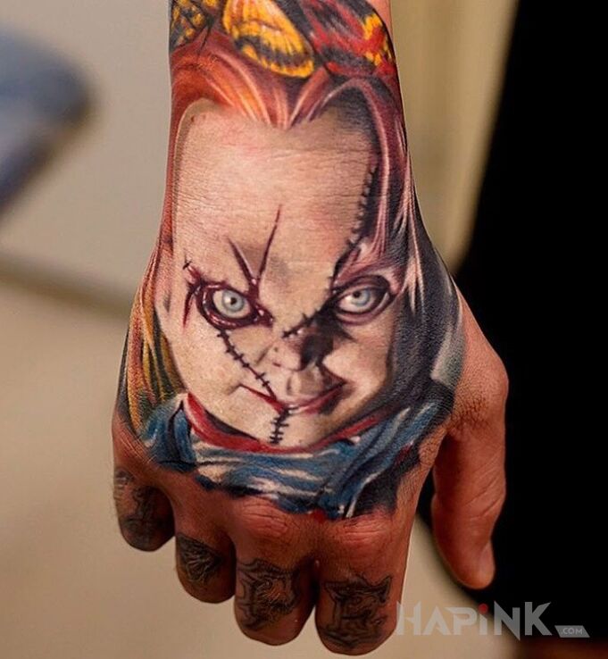 Tattoo Laleczka Chucky in characters motif on the hand