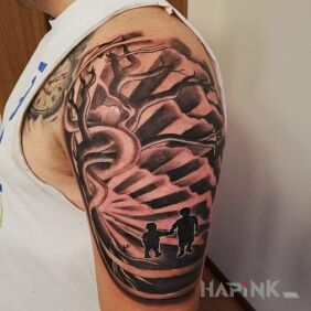 Tattoo Children on the upper arm motif: black and gray style: graphic / illustrative