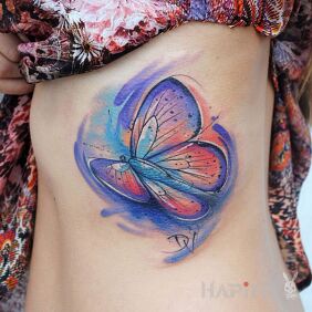 Tattoo Blue butterfly on the ribs motif: colorful