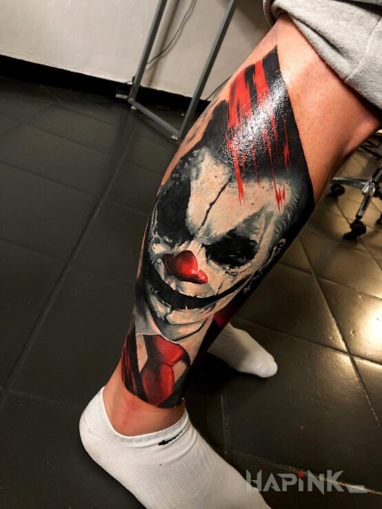 Tattoo Joker in colorful motif and realistic style on the calf