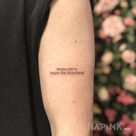 Tattoo In Spanish on the upper arm motif: lettering style: calligraphy