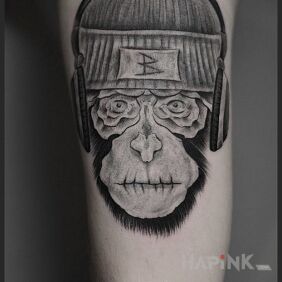 Tattoo Monkey BdoR on the upper arm motif: faces