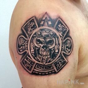 Tattoo Aztec sun on the upper arm motif: black and gray style: graphic / illustrative