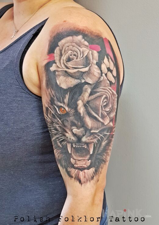 Tattoo Tygrysek in black and gray motif and realistic style on the upper arm
