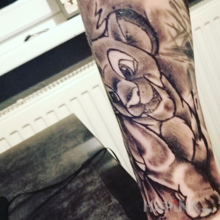 Tattoo Simba in black and gray motif and graphic / illustrative style on the forearm