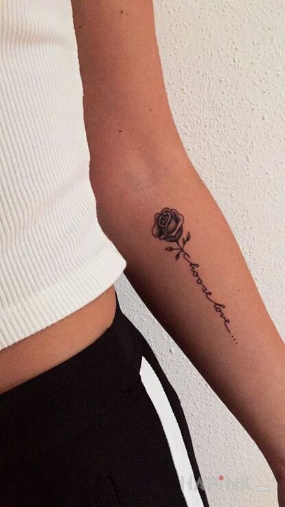 Tattoo Wybierz miłość in lettering motif and graphic / illustrative style on the forearm