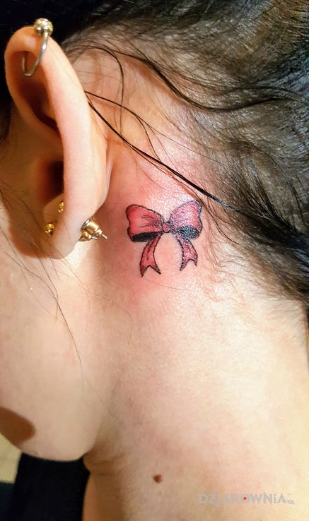 Tatuaż kokarda w motywie przedmioty i stylu minimalistyczne za uchem