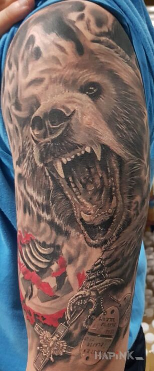 Tattoo Miś Wojtek in black and gray motif and realistic style on the upper arm