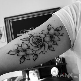 Tattoo Flowers on the upper arm motif: black and gray style: graphic / illustrative