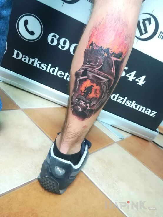 Tattoo Fireman in colorful motif and realistic style on the calf