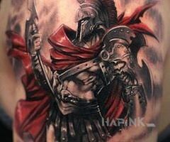 Tattoo Spartan in characters motif on the upper arm