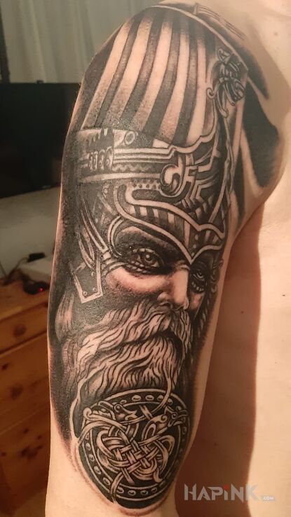Tattoo Wiking i lodz czesc 1 in faces motif and realistic style on the upper arm