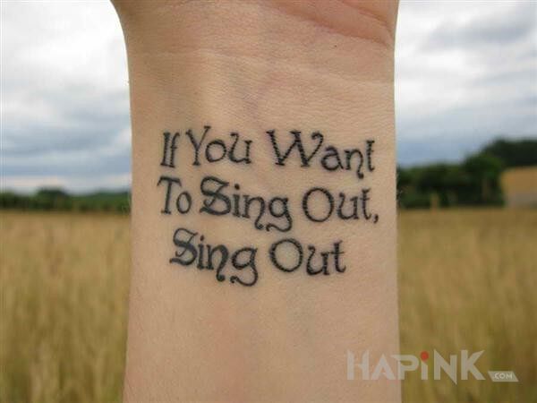 Tattoo If You Want To Sing Out, Sing Out in lettering motif on the wrist