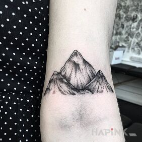 Tattoo Mountains on the forearm motif: black and gray style: graphic / illustrative