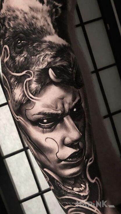 Tattoo Dzik in dark motif and realistic style on the forearm