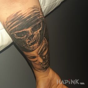 Tattoo Skull with mask on the forearm motif: demons style: realistic