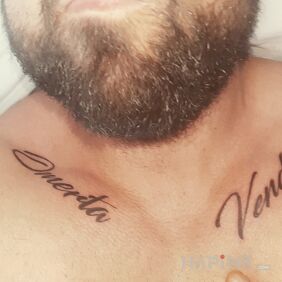 Tattoo Omerta and Vendetta on the collarbone motif: lettering style: calligraphy