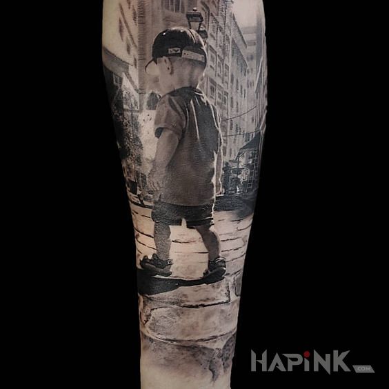 Tattoo Chłopaczek in black and gray motif and realistic style on the forearm