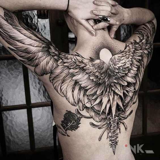 Tattoo Uskrzydlony in wings motif and realistic style on the upper arm