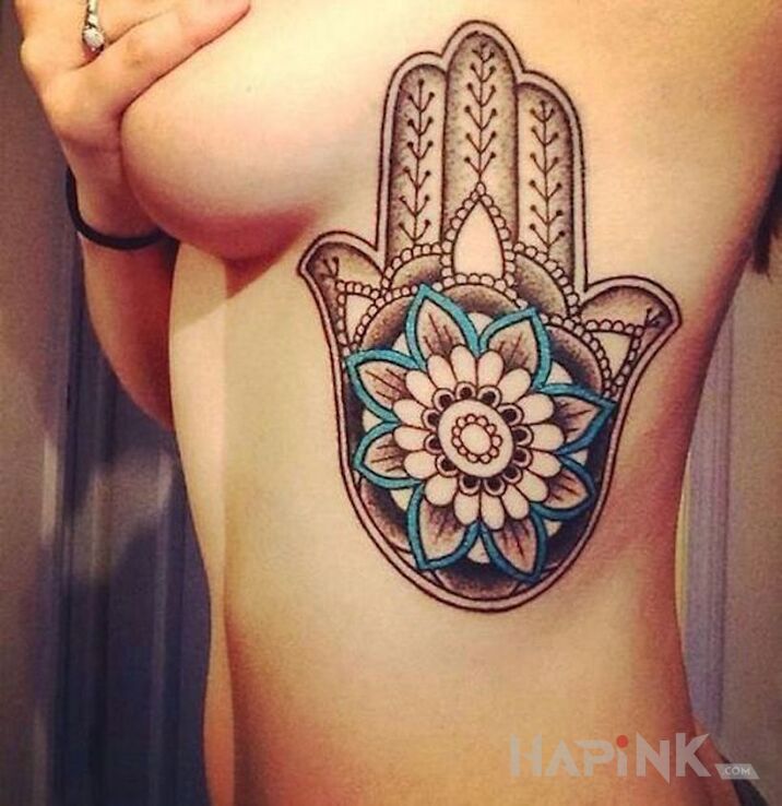 Tattoo Chamsa in black and gray motif and graphic / illustrative style on the ribs