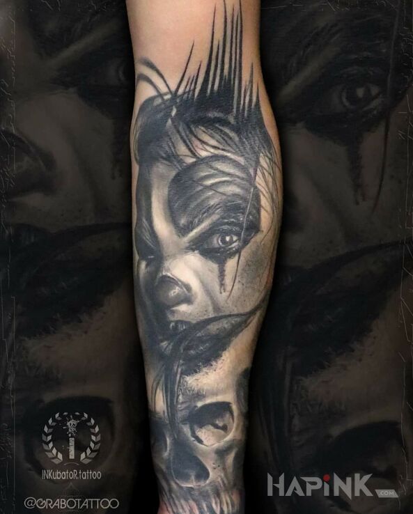 Tattoo DemonicznyKlaun in skulls motif and realistic style on the forearm