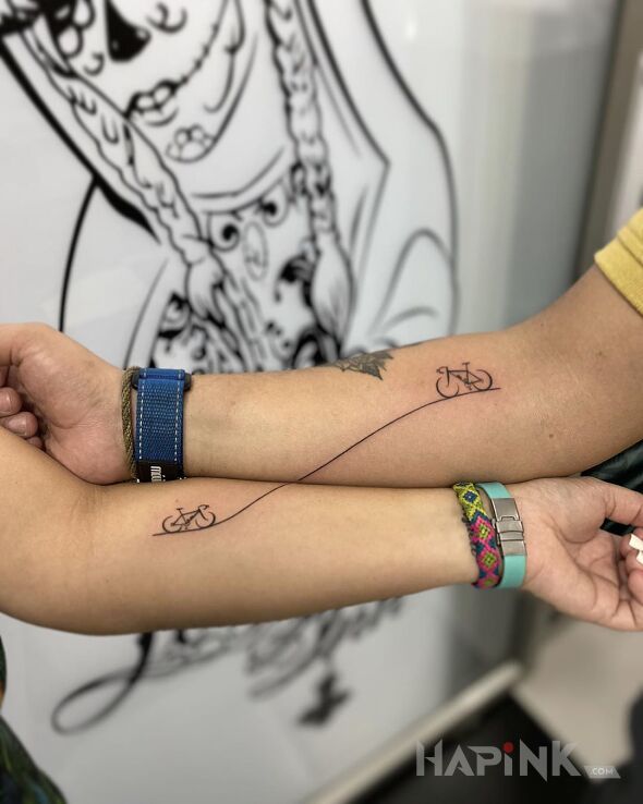 Tattoo Miłośnicy rowerów in Love motif and minimalistic style on the forearm