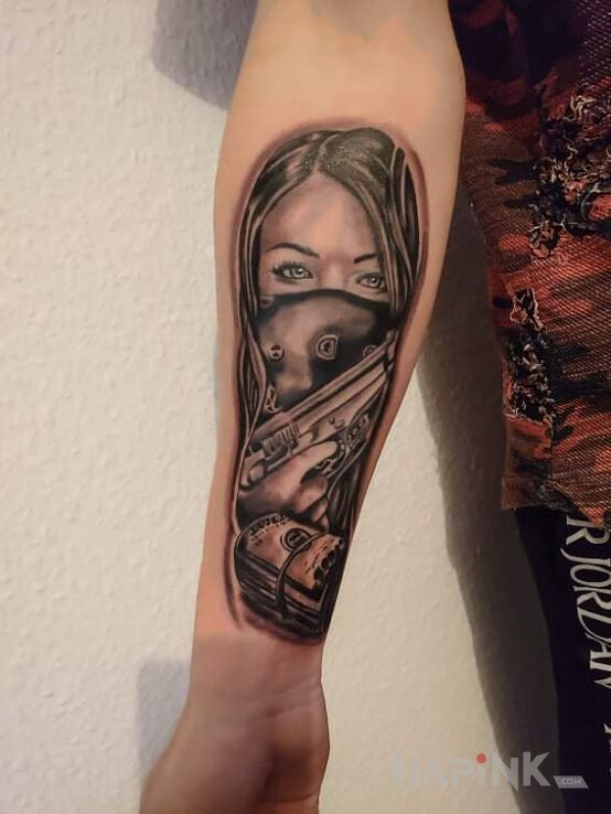 Tattoo Dziewczyna z pistoletem in objects motif and realistic style on the forearm