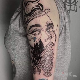 Tattoo Something. on the upper arm motif: faces style: graphic / illustrative