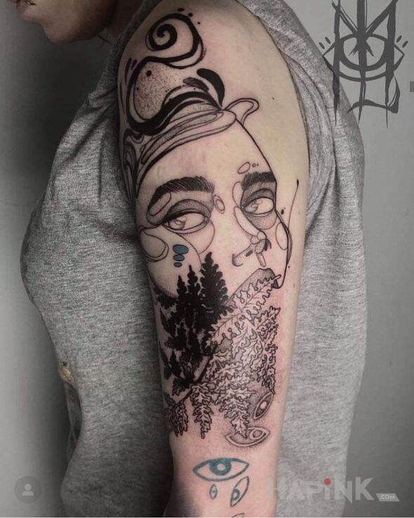 Tattoo Coś. in faces motif and graphic / illustrative style on the upper arm
