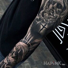 Tattoo Jesus Christ on the upper arm motif: faces style: realistic