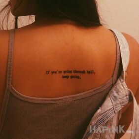 Tattoo The road through hell on the back motif: lettering style: calligraphy