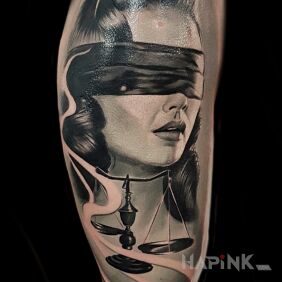 Tattoo Temida on the upper arm motif: black and gray style: realistic