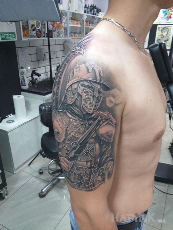 Tattoo Husaria in black and gray motif and realistic style on the upper arm