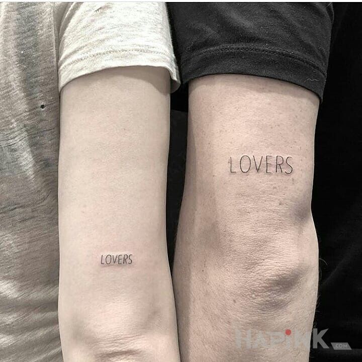 Tattoo Lovers in lettering motif and calligraphy style on the upper arm
