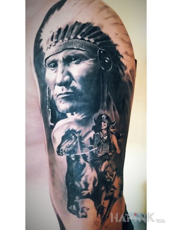 Tattoo Indianin in faces motif and realistic style on the upper arm