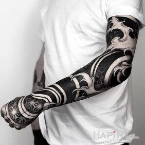 Tattoo Black work on the upper arm motif: sleeves style: blackwork / blackout