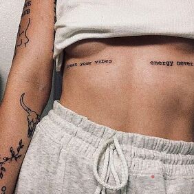 Tattoo Positive vibes on the stomach motif: lettering style: calligraphy