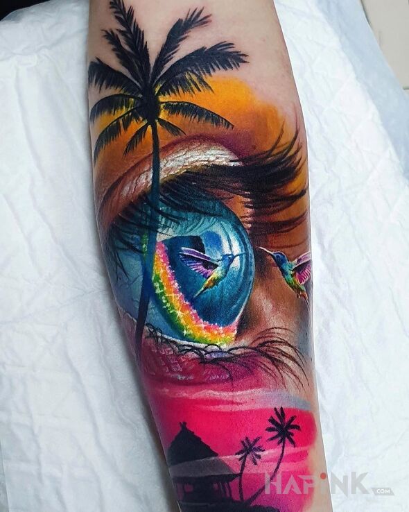 Tattoo Koliberek in colorful motif and realistic style on the forearm